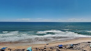 A beach with waves, a clear sky, and a visible moon. - Oceanside Retreat 805 | Pet-Friendly + Ocean Views (Ormond Beach)