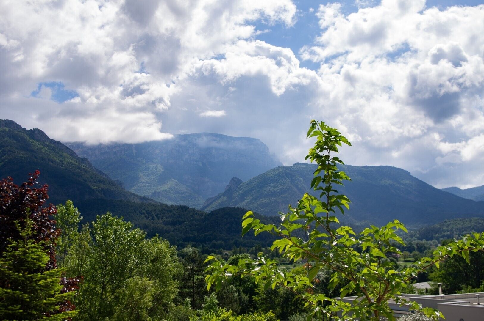 A mountainous landscape with lush greenery and a clear sky.