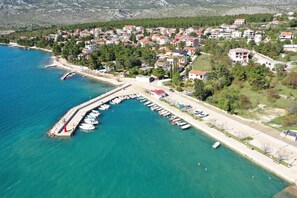 An aerial view of a coastal town with a marina, residential buildings, and a pier. - Apartment Marina No.2 with Sea View (Rovanjska)