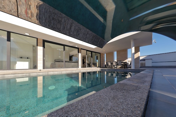 A modern indoor pool with clear water, large windows, and a contemporary design. - Villa Astur with Private Pool (Zemunik Gornji)