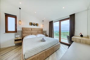 A modern bedroom with a large bed, a view of the sea, and a minimalist design. - Villa Masanda with Pool (Dobropoljana)