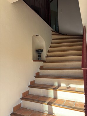 Un escalier avec des murs de couleur beige et des marches en bois.
