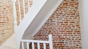 A white staircase with a brick wall background. - Magnificent house in the heart of Douai (Douai)