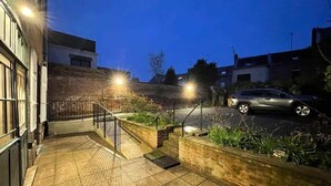 A nighttime outdoor area with a paved walkway, steps, and a parked car. - Spacious Quiet Studio • Fully Equipped • Amiens Centre • 5-min Walk to Station • Parking on Site (Amiens)