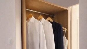 A wooden wardrobe with hanging space and drawers. - Spacious Quiet Studio • Fully Equipped • Amiens Centre • 5-min Walk to Station • Parking on Site (Amiens)