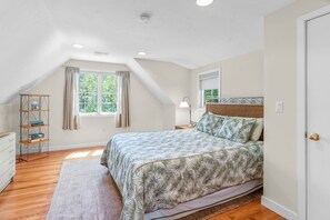 A bedroom with a bed, a window, a shelf, and a door. - New Rental-Bright Coves, Walk to Marina and Popponesset Spit and clean! (Mashpee)
