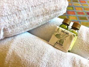 A bottle of olive oil and a towel on a textured surface. - 2 Bedrooms Commandant André 41 by Viva Riviera (Cannes)