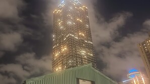 A high-rise building with multiple illuminated windows and a visible 'HYATT REGENCY' sign. - City-Chic at Centennial Hill downtown (Atlanta)