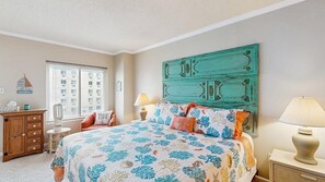 A bedroom with a bed, a dresser, a lamp, and a window with blinds. - Royal Hawaiian 205 (Ocean City)