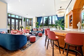 A modern lounge area with sofas, chairs, a bar, and large windows. - 2BR apartment with heated pool in miami (Miami)