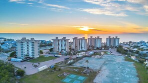 A high-rise residential building complex with a view of the sunset over the ocean. - Spectacular Gulf Views Close To Beach Studio 4606 (Bonita Springs)