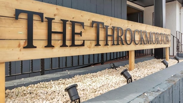 A wooden sign with the text 'THE THROCKMORTON' in capital letters. - The Throckmorton (Alcester)