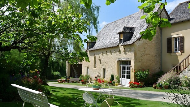 A stone building with a garden, a bench, and a table with chairs. - Guest Room “La Grange De La Bonaurie - Sienne” with Shared Terrace, Garden, and Wi-Fi (Anglars-Saint-Félix)