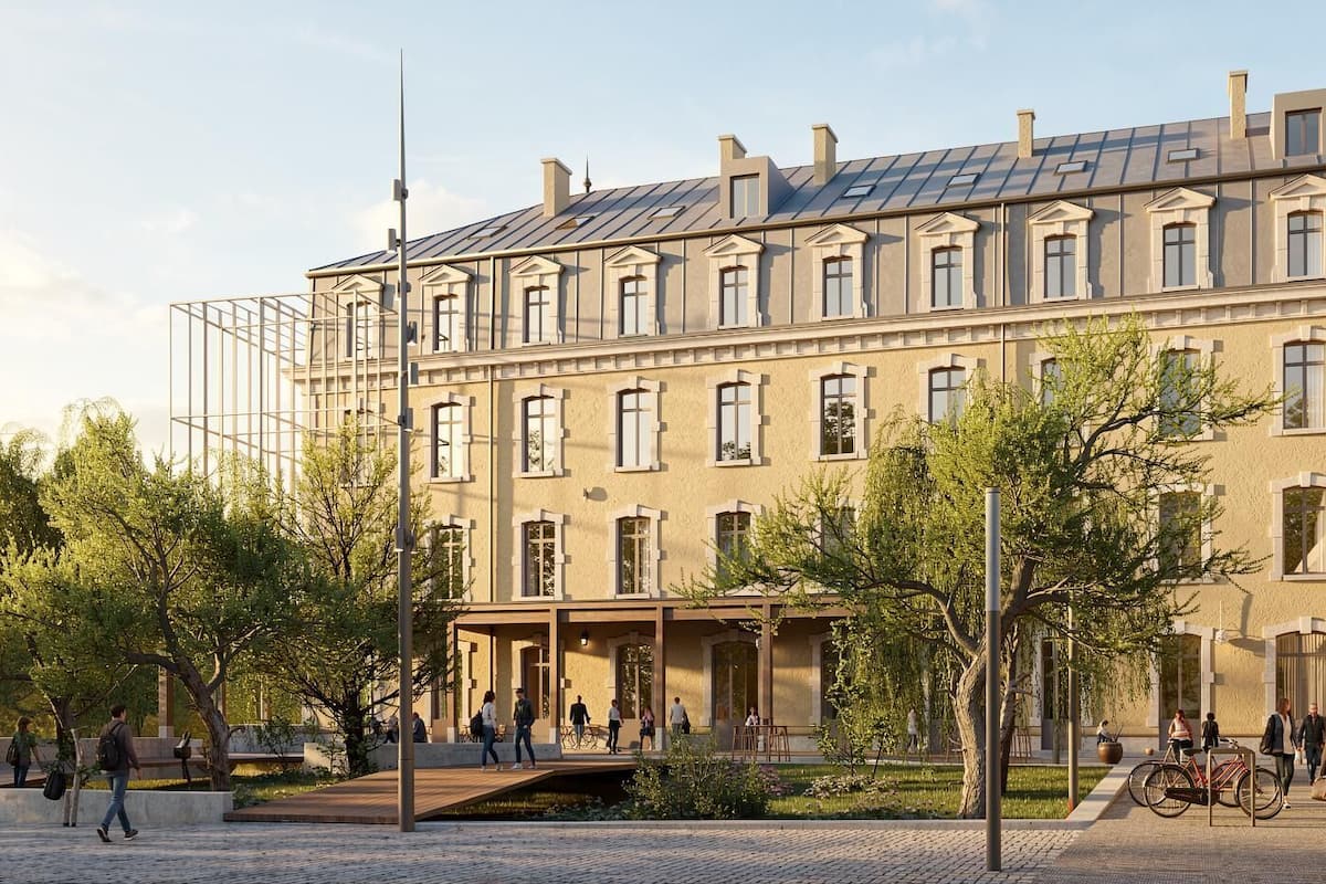 A building with a classical facade, multiple windows, and a covered entrance area.