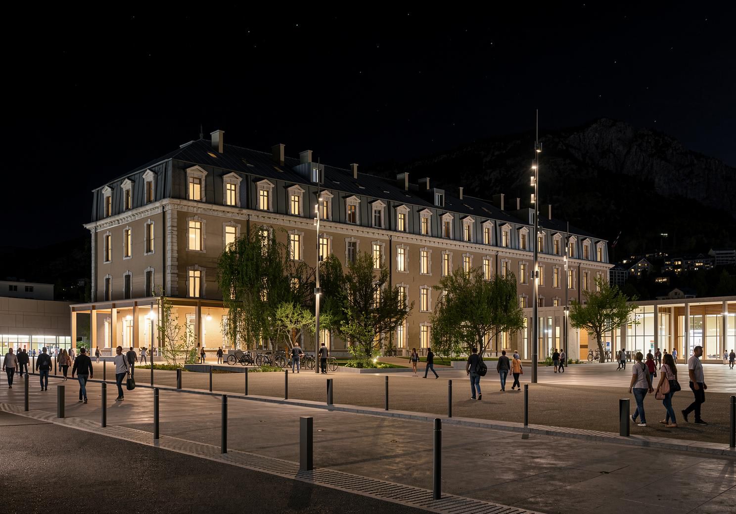 Un grand immeuble à étages, de style architectural classique, doté d’une cour intérieure avec des arbres et d’un chemin piétonnier dallé.