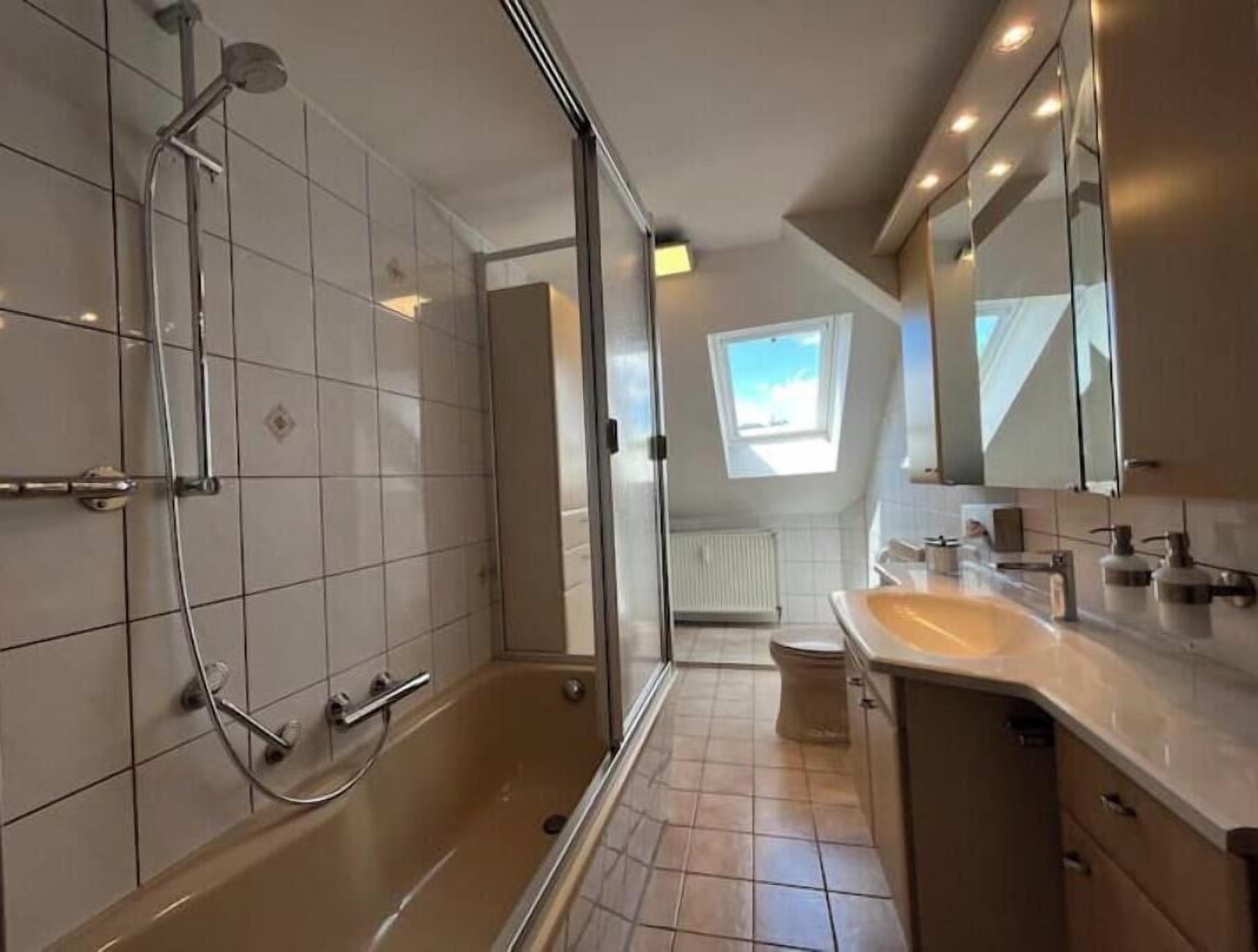 Un baño moderno con ducha, inodoro y lavamanos.