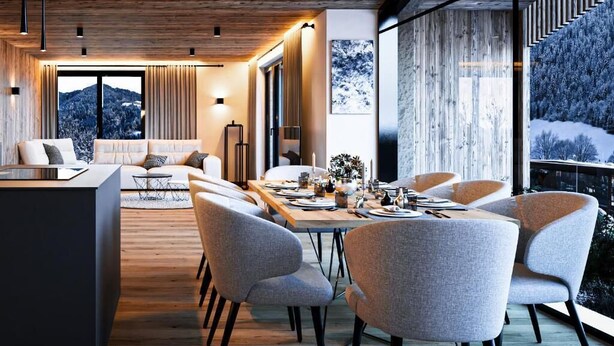 A modern interior with a dining area, sofas, and a view of a snowy landscape. - Wieshof Wilder Kaiser by ALPS RESORTS (Soell)