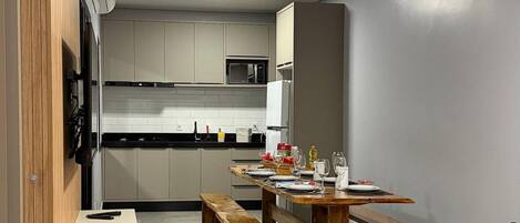 Una cocina moderna con comedor, un sofá y un tapete de cuero negro.