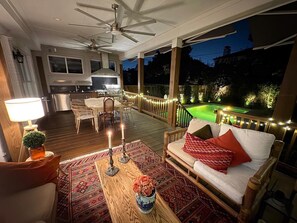 An outdoor deck with a dining area, a sofa, and a pool. - Cozy House Retreat Near Texas Medical Center. (Houston)