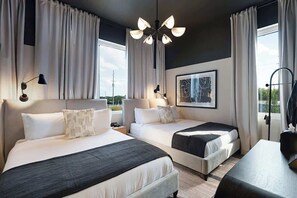 A hotel room with two beds, a desk, a chair, a ceiling light, and a window with curtains. - Modern 4BR Escape|Hot Tub, Sauna&Pool! Game Room! 11 beds! (Nashville)