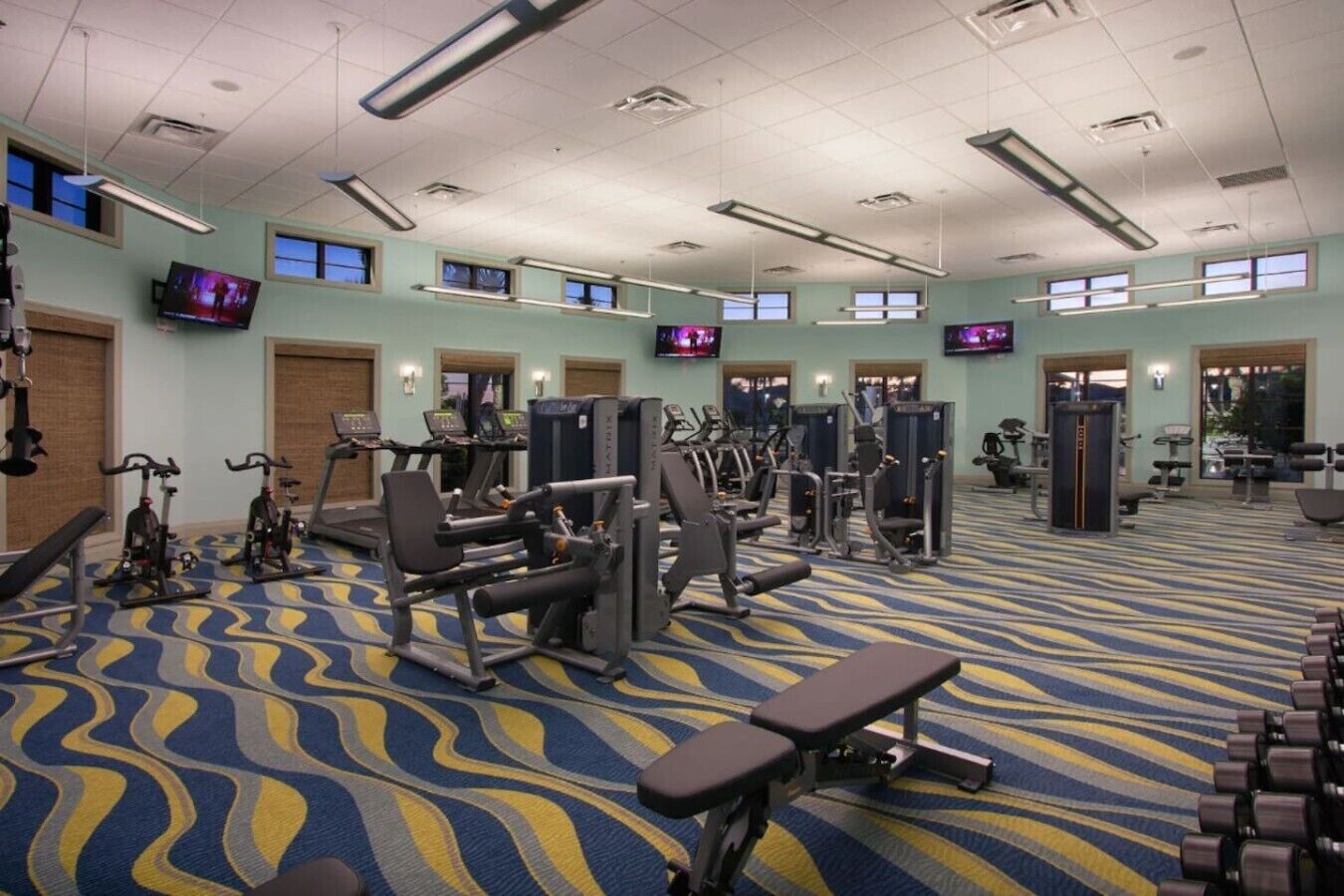 A gym with treadmills, weight machines, and exercise equipment.
