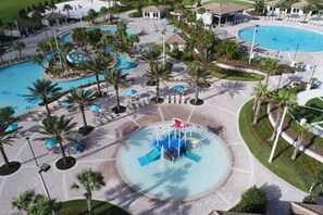 A resort with multiple swimming pools, palm trees, and a central water feature. - Magic Awaits: Modern 3BR Family Retreat (Kissimmee)
