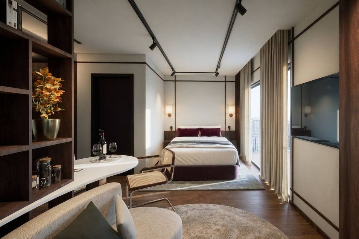 A modern hotel room with a bed, a desk, a chair, a bookshelf, and a large window with a city view.
