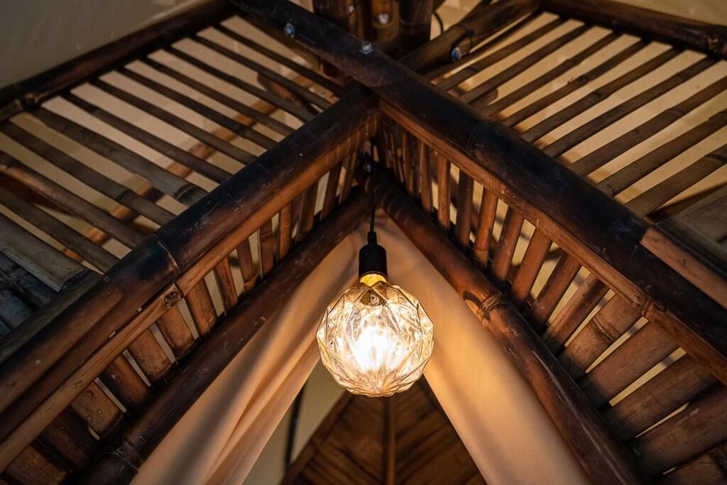 A wooden ceiling structure with a hanging light fixture.