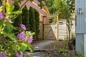 A gated entrance with a wooden gate, a mailbox, and a mailbox number 963B. - Urban oasis, Central District - Studio (Seattle)