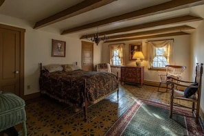 A traditional room with a bed, a dresser, a chair, and a chandelier. - Beautiful peaceful country home on 18 acres built 1800 (Ryegate)