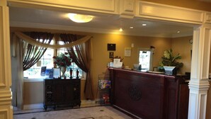A lobby with a marble floor, a reception desk, and a window with curtains. - Days Inn by Wyndham Victorville/hesperia I-15 & P (Victorville)