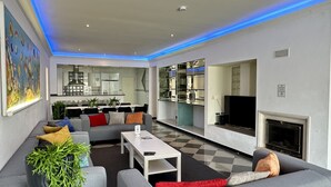 A modern living room with a sofa, coffee table, and a fireplace. - Yellow | Private pool | 12 Pax | Albufeira (Albufeira)