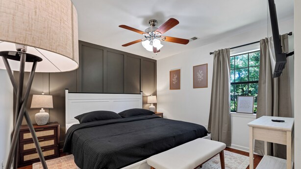 A bedroom with a bed, bedside tables, a ceiling fan, a window with curtains, and a desk. - Game Room+Xbox, 15 Min to Memphis & Tunica Casino (Horn Lake)