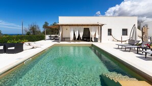 A modern villa with a swimming pool, outdoor seating, and a view of the sea. - Symphony Sound By BarbarHouse (Sannicola)