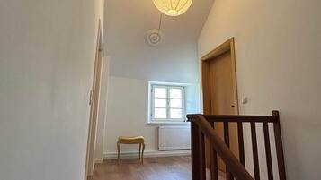A staircase with wooden railings leading to a landing.