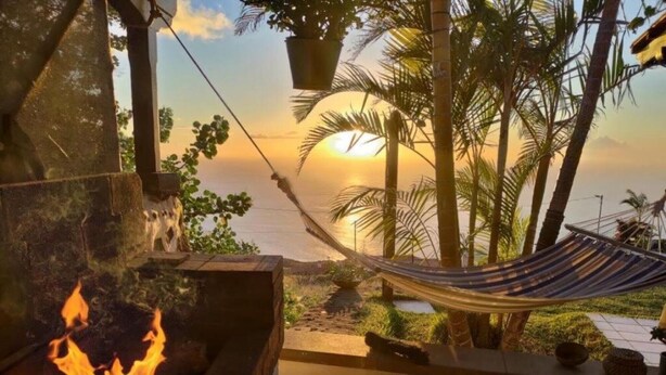 A hammock, a fire pit, and a view of the sunset over the ocean. - Apartment 'Casa' with Sea View, Wi-Fi and Air Conditioning (Los Quemados)