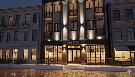 A hotel with a modern facade, large windows, and a prominent entrance.. Fethibey Otel