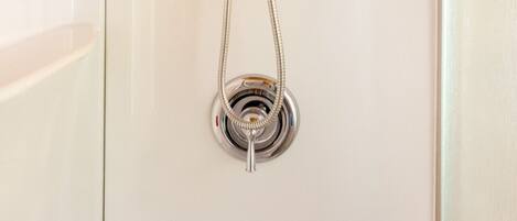 A shower with a handheld showerhead and a flexible hose.
