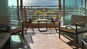 A balcony with a view of the sea, a table, and two chairs. - TheTimeless Haven PR@ Oceanfront Escape- Maunabo (Maunabo)