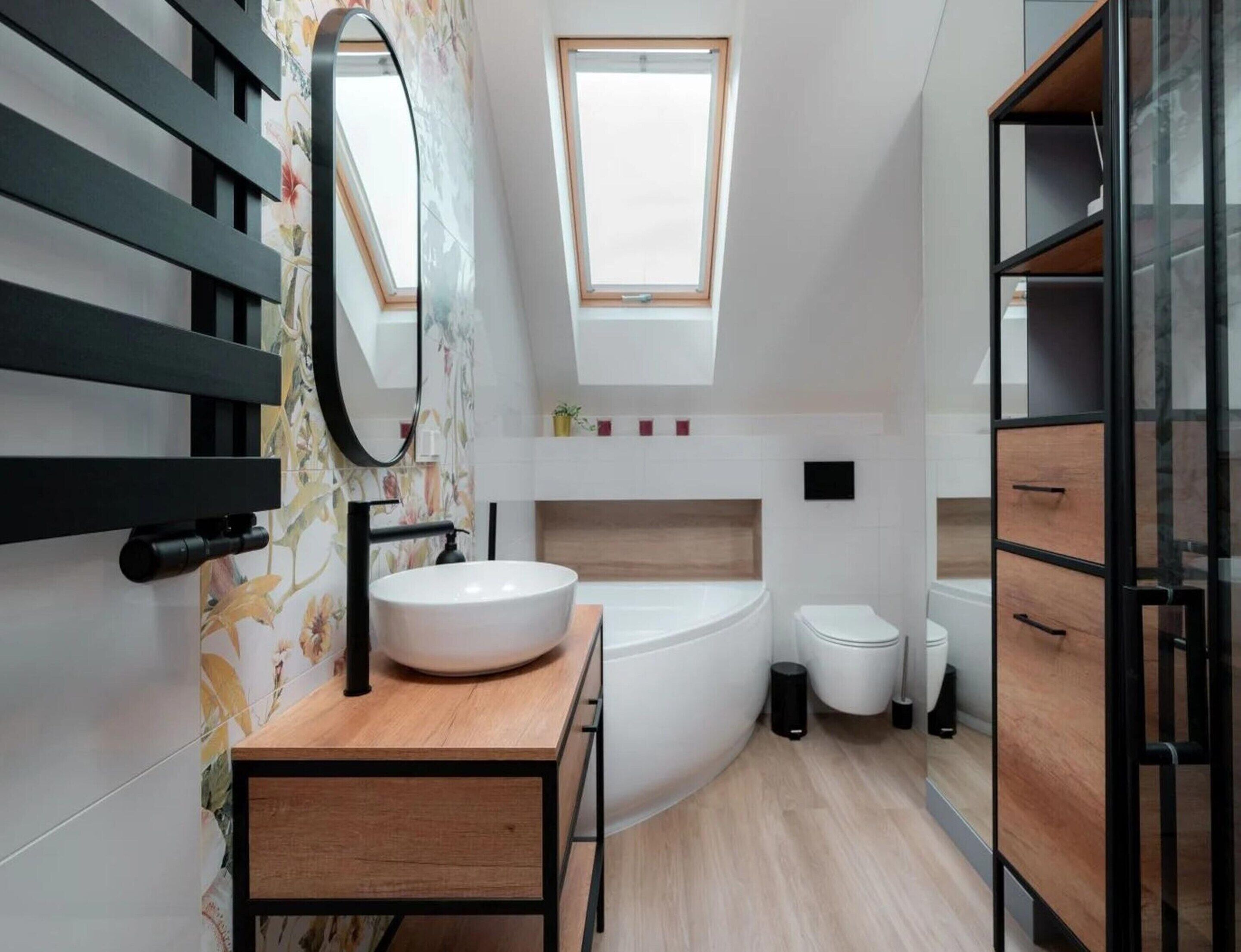 A modern bathroom with a freestanding sink, a bathtub, and a toilet.