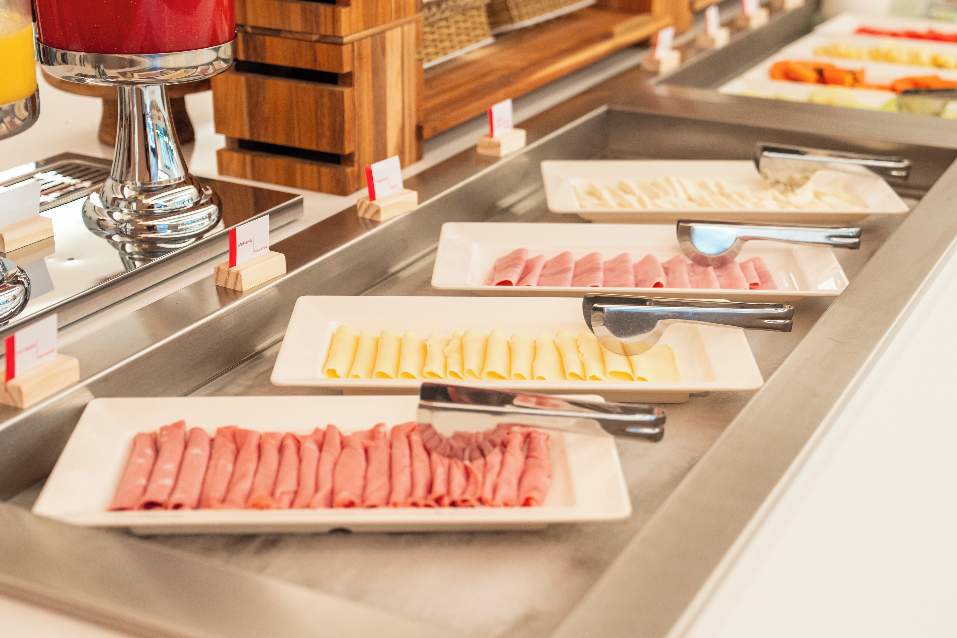 A buffet with various food items and utensils.