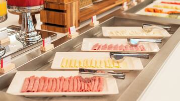 A buffet with various food items and utensils.
