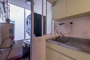 A kitchen with a sink, cabinets, and a window. - Mexican 2BR - 2Bath of Condesa - Wifi High Speed (Mexico City)