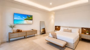 A modern bedroom with a large bed, a bedside table, a nightstand, a bench, a TV, and a mirror.