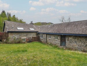 A stone cottage with a sloped roof, a small window, and a door. - Culearn Mill (Lochearnhead)