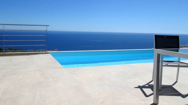 A clear blue sky, a swimming pool, and a view of the ocean. - MAGNIFICENT VILLA WITH POOL, SPA AND SEA VIEW (Cerbère)