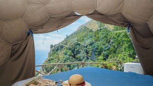 A tented room with a view of a forested hillside. - De Vivo Realty - Boscosfera Amalfi (Amalfi)