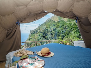 A tented room with a view of a forested hillside. - De Vivo Realty - Boscosfera Amalfi (Amalfi)