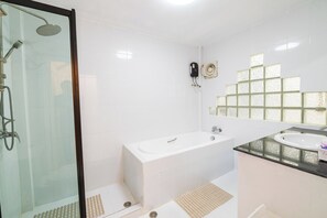 A bathroom with a glass-enclosed shower, a standalone bathtub, and a sink with a countertop. - 3-bedroom townhome in delightful Pattaya City with AC (Pattaya City)