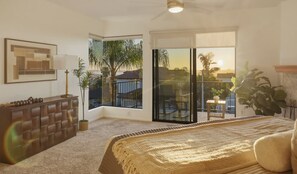 A bedroom with a large window, a ceiling fan, a bed, and a view of a balcony. - Luxury 4-bdrm home / Amazing Location / close to beach and attractions (San Diego)